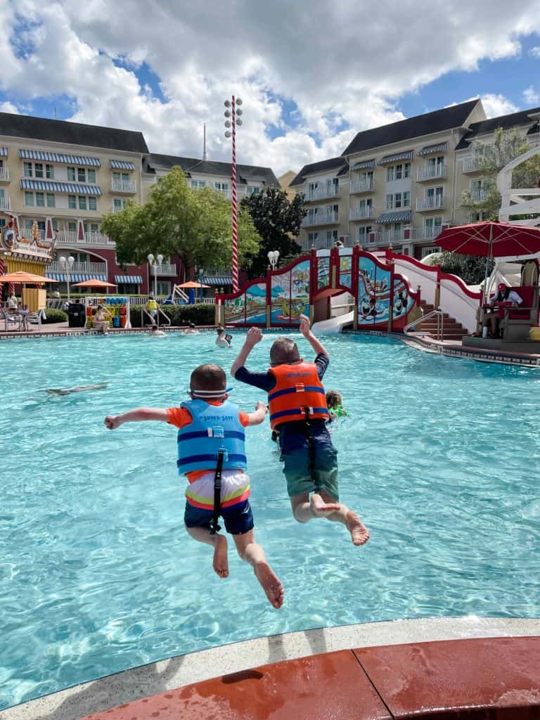 Brothers jumping into pool at Disney's Boardwalk