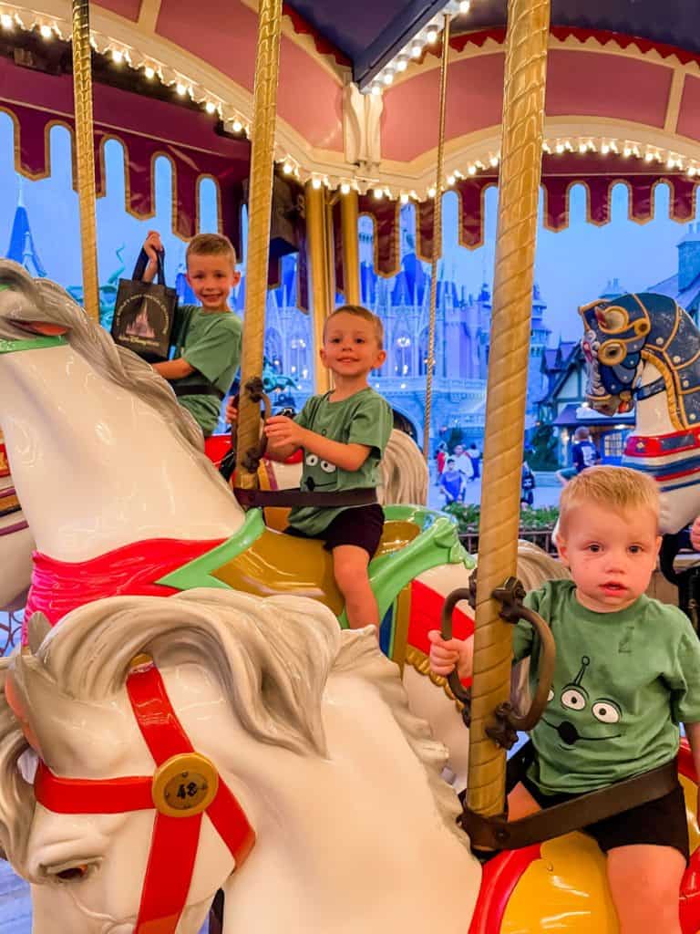 Three boys on Magic Kingdom's carrousel