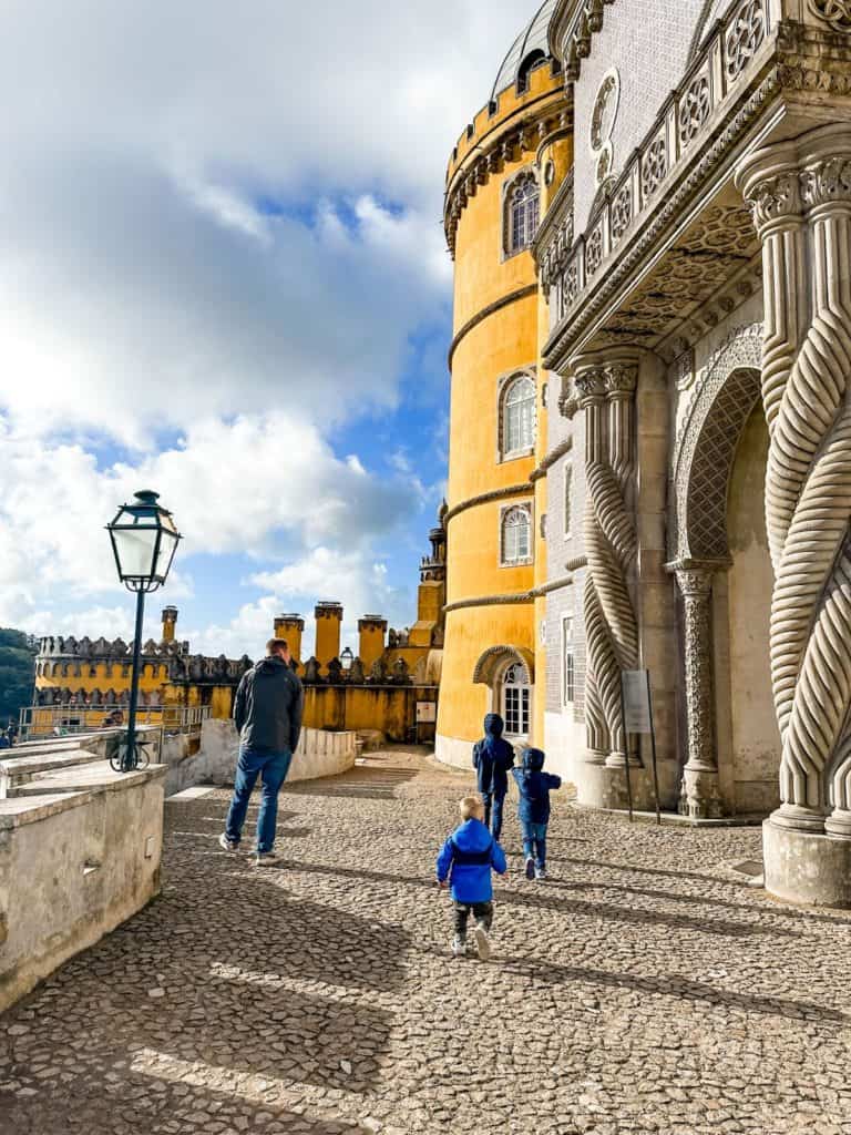 Dad and boys walking around Pena Palace when visiting Sintra with kids