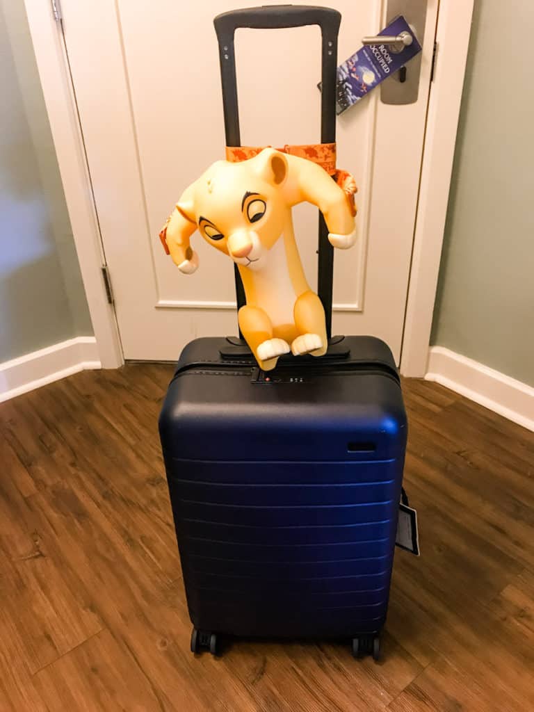 Suitcase and Lion King popcorn bucket, what to pack for Disney World, Free printable Disney packing checklist