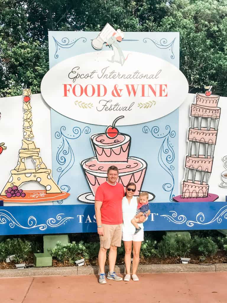 Parents and son standing in front of Epcot Food & Wine Festival