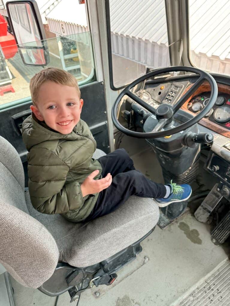 Boy smiling in the driver's seat of the Ice Explorer on the Columbia Icefield Adventure