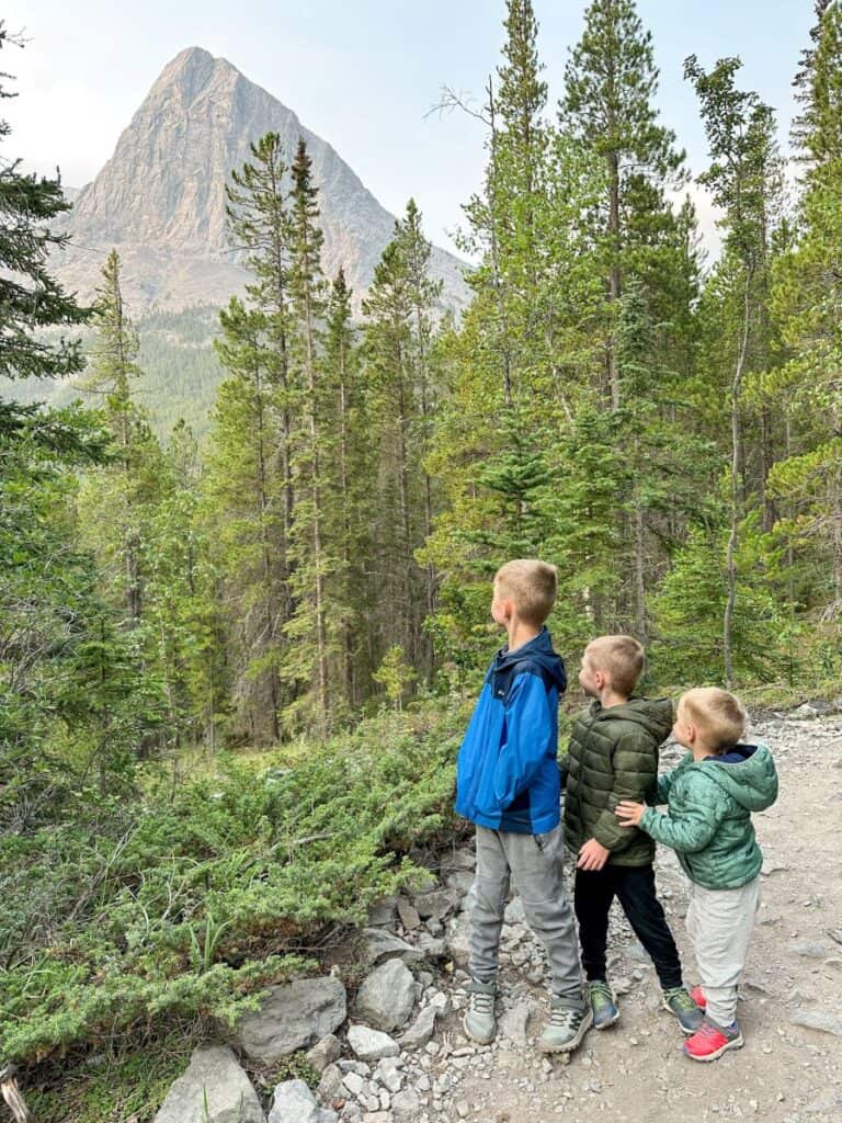 Boys looking out at Ha Ling Peak from Grassi Lakes trail in Canmore
