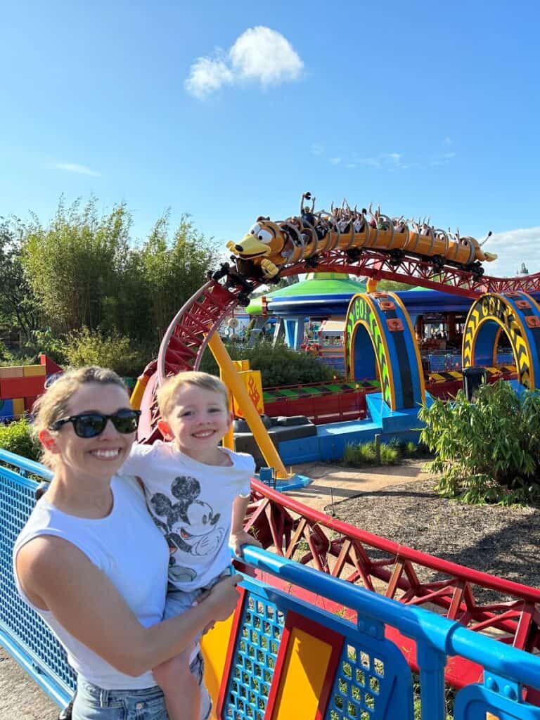 Mom and son smiling in front of Slinky Dog Dash at Hollywood Studios